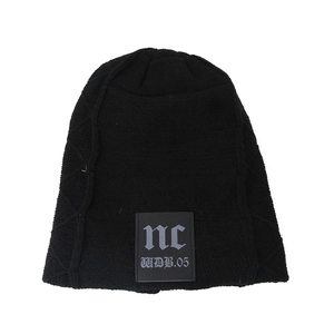 Detail of black knit beanie with square letter patch and diamond texture pattern