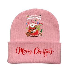 Detail of pink knitted Christmas hat with cartoon Santa Claus and reindeer patterns