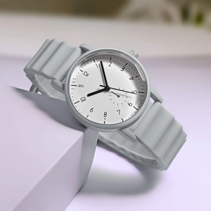 Detail of grey minimalist quartz watch with creative wavy silicone strap on soft purple base