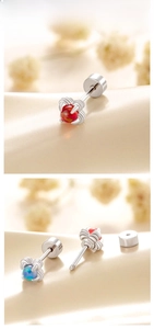 Macro view of claw-set opal and amber dragon ball studs with screw-back detail