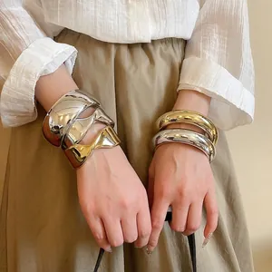 Minimalist chunky wave metal bangles in gold and silver finish for fashion jewelry