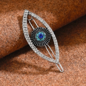 Macro detail of silver punk Evil Eye hair clip with sparkling rhinestones and blue crystals