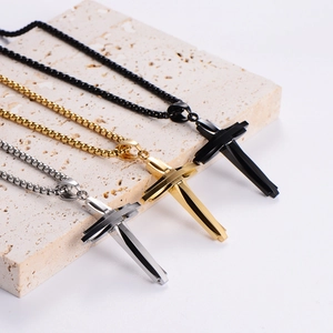 Three men's stainless steel cross necklaces in silver, gold, and black colors