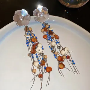 Bohemian floral resin bead earrings with tassels featuring blue and orange accents