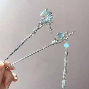 Silver crescent moon and star hair sticks with pale blue stones and long tassels