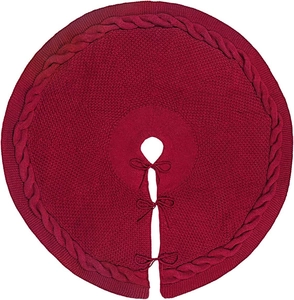 Detailed knit texture of burgundy Christmas tree skirt with braided pattern and ties