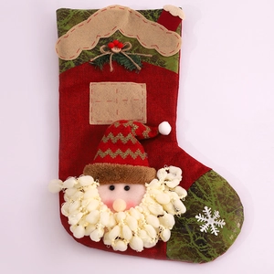 Detail of burlap Christmas stocking featuring 3D Santa Claus with soft pom-pom beard