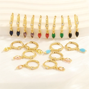Macro shot of 18K gold plated earrings with colorful marquise stones and spiral patterns