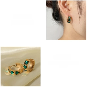 Detail of 18K gold plated earrings featuring inlaid green heart-shaped zircon stones