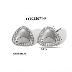 Close-up of silver triangle stud earrings featuring pavé crystals and size markers