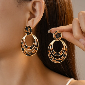 Detail of leopard print flocking three-layer hoop earrings worn by a model