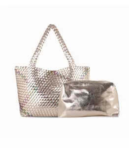 Detail of woven champagne gold tote with holographic sequins and matching metallic pouch