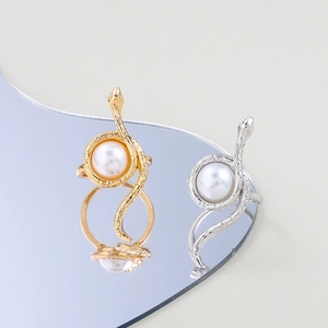 Snake wrap rings in gold and silver finish featuring a large pearl and scale texture