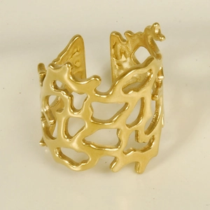 Macro detail of gold irregular hollow out coral pattern ring with open adjustable band