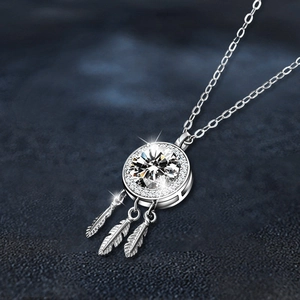 Moissanite 925 sterling silver dreamcatcher necklace with sparkling feathers on dark surface