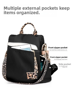 Detailed interior storage showing iPad and phone inside leopard print nylon backpack