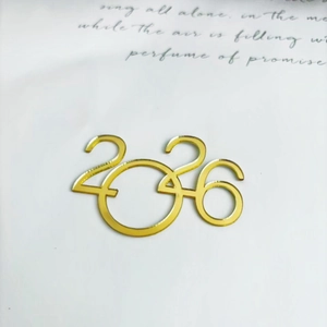 Macro view of gold mirror acrylic 2026 number topper for Christmas cake decoration
