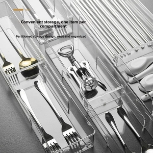 Close-up of clear plastic drawer organizers with silverware for kitchen storage