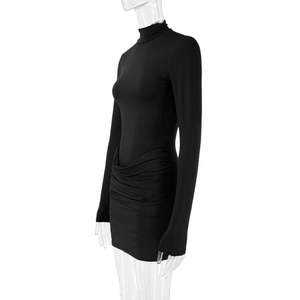 Detail of side ruching and slim fit texture on a black long sleeve mini dress