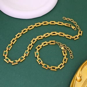 Macro shot of 18K gold plated stainless steel necklace with green square gemstones