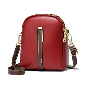 Red PU leather crossbody bag for women with dual zippers and brown decorative strap