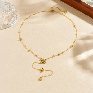 Elegant gold Y-shaped necklace featuring butterfly and flower pendants with clear gems