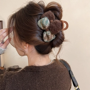 Vintage velvet bow hair claw clip with fur detail shown on model from a side profile view