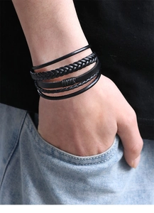Close-up of black multilayer braided leather bracelet with magnetic clasp on wrist