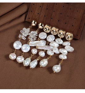 Macro shot of baroque freshwater pearls and gold-plated hardware on brown velvet