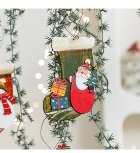 Macro detail of painted wooden Christmas stocking ornament with Santa and gift motifs