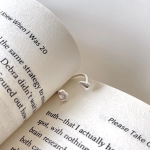 Elegant S925 sterling silver open ring featuring a dual heart design on book pages