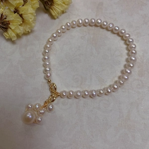 Close-up of Baroque freshwater pearls with 14K gold plated clasp and pearl cluster detail
