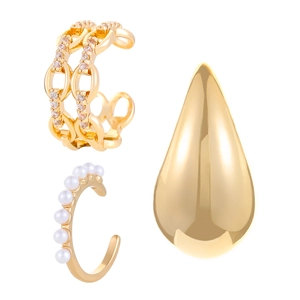 Detailed close-up of gold ear cuffs with zircon pavé, pearls, and teardrop stud earring