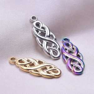 Macro detail of witch knot pendants in gold, silver and aurora finishes on silk