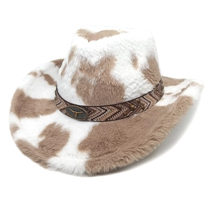 Close-up of cow-print faux fur texture with braided band and metal bull-head emblem