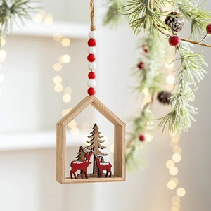 Hanging wooden Christmas reindeer ornament in house frame for holiday tree decoration