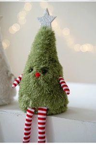 Detail of plush Christmas tree doll with soft faux fur and red striped limbs in warm lighting