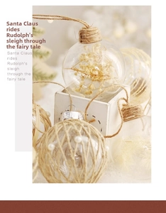Detailed close-up of rustic Christmas balls with twine and dried flower accents in a wooden box