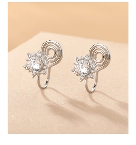 Detailed close-up of s925 silver sunflower ear clips with sparkling zircon stones