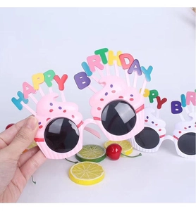 Close-up of pink cupcake birthday party glasses with Happy Birthday lettering detail