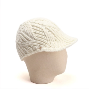 Detail of white chunky knit visor beanie featuring cable texture and gold button detail