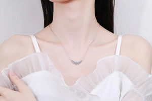 Elegant s925 silver smile necklace with sparkling moissanite stones on a model's neck