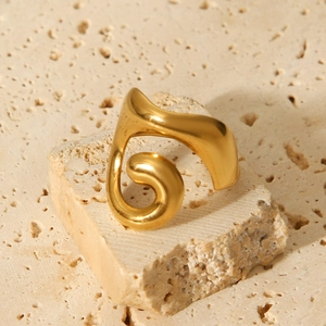 Minimalist 18K gold plated stainless steel hollow twisted ring on beige stone base