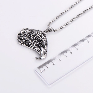 Detailed view of punk eagle head pendant with ruler showing size measurement