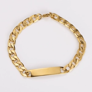 Macro shot of 7mm golden stainless steel Cuban chain bracelet with blank metal nameplate