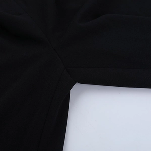 Detailed macro view of the black slim fit trousers showing fabric texture and inner seam
