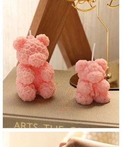 Detailed texture of pink rose bear scented candles in small and large sizes
