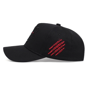 Black cotton baseball cap with red embroidered claw marks shown from a side profile
