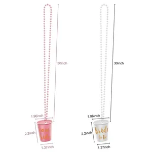 Pink and white Bride to Be party shot glass necklaces with Team Bride printed lettering