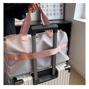 Travel bag with trolley sleeve attachment for suitcase luggage in grey and pink